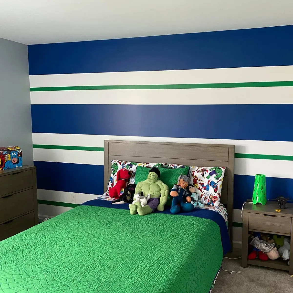 Child's bedroom with a custom blue and green striped painted accent wall